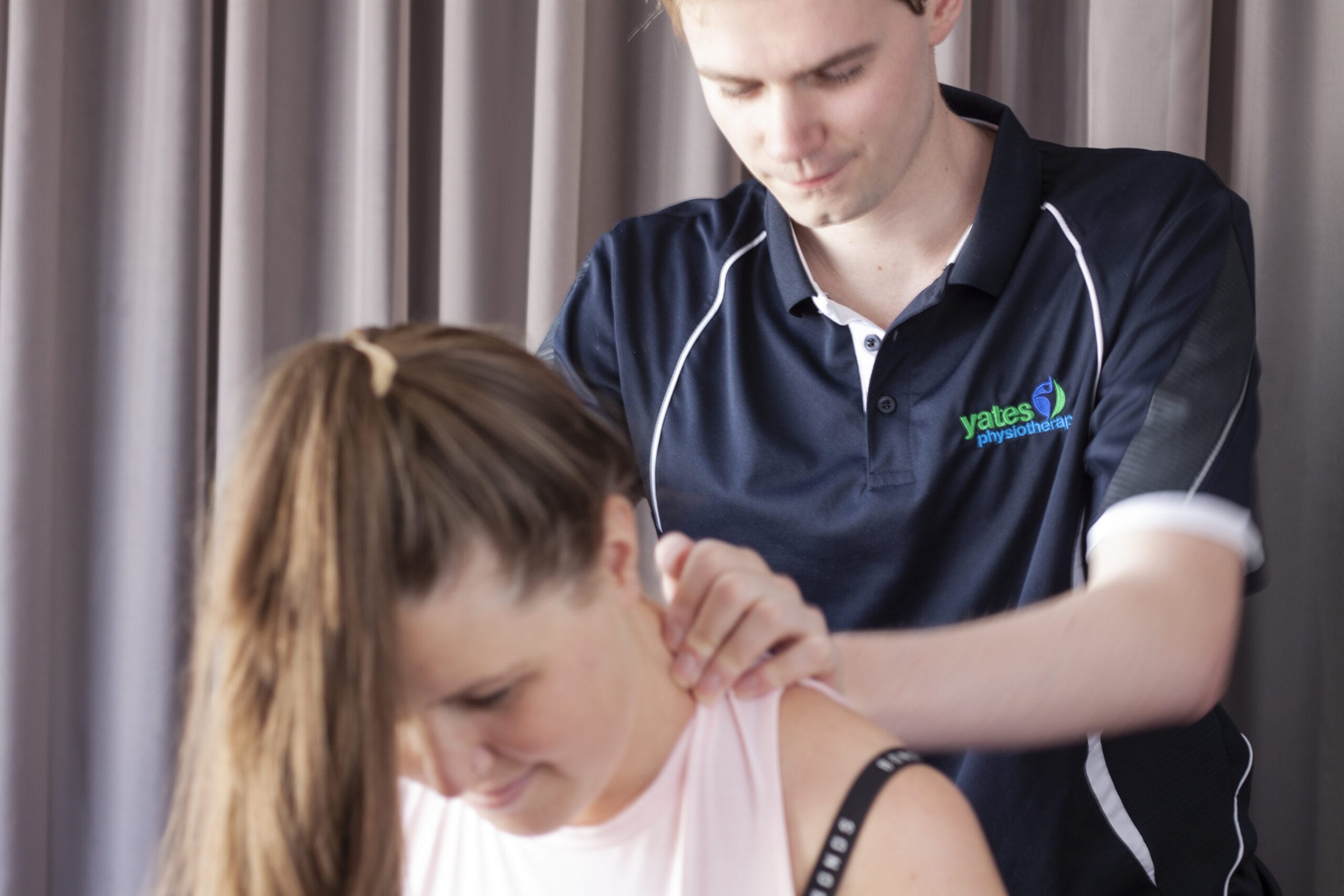 A physiotherapist providing a shoulder massage in Adelaide to alleviate pain and tension