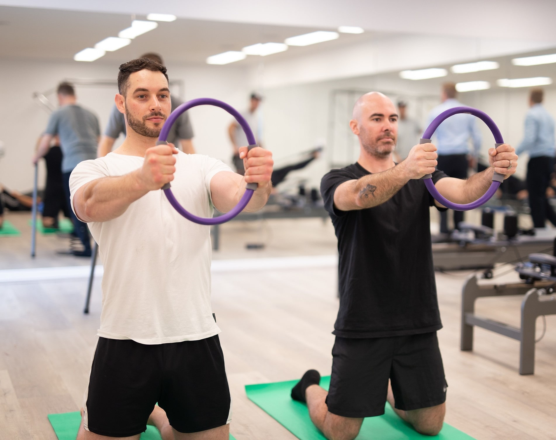 Patients using Pilates rings during a physiotherapy session in Adelaide for pain relief and muscle strengthening