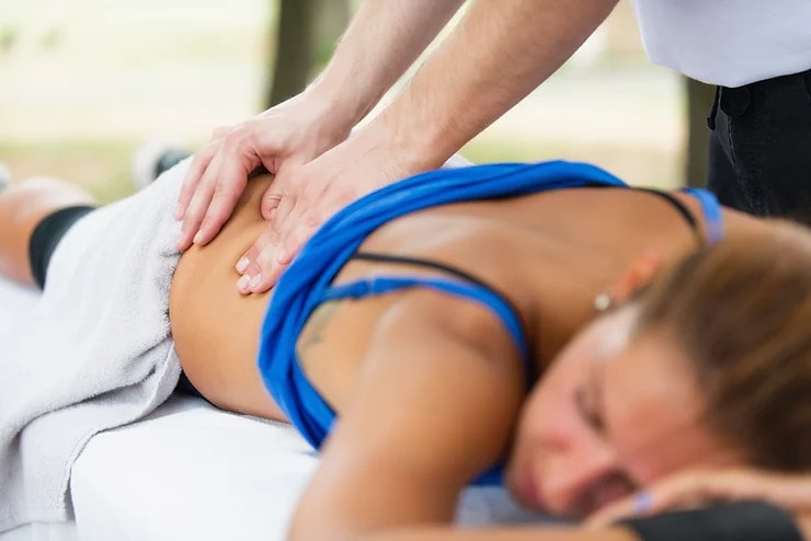 A physiotherapist providing a remedial back massage in Adelaide to alleviate pain and relax muscles